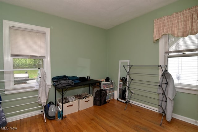 misc room with plenty of natural light, wood finished floors, and baseboards