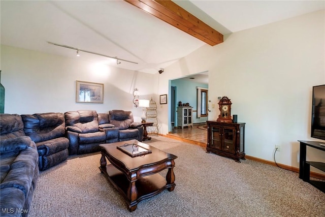 living room featuring rail lighting, carpet floors, beam ceiling, and baseboards