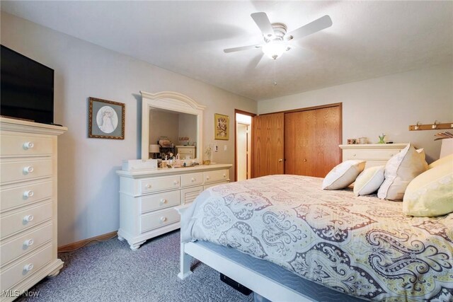 bedroom featuring light colored carpet, a closet, baseboards, ceiling fan, and ensuite bathroom
