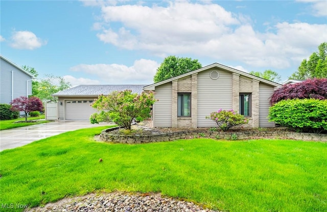 mid-century modern home featuring concrete driveway, a front yard, and an attached garage