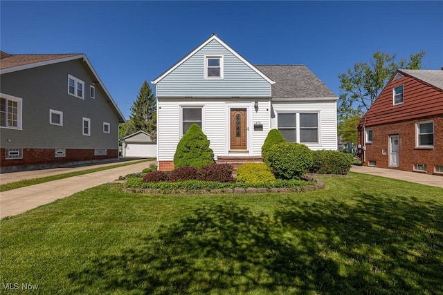 1278 Washington Blvd, Mayfield Heights, OH 44124 - view of front of property with an outdoor structure, a front yard, a garage, and roof with shingles