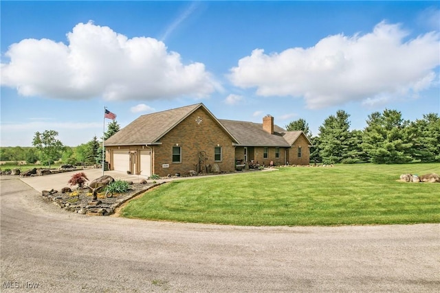 12094 Snode St NE, Alliance, OH 44601 - view of front of house with a chimney, concrete driveway, stone siding, and a front yard