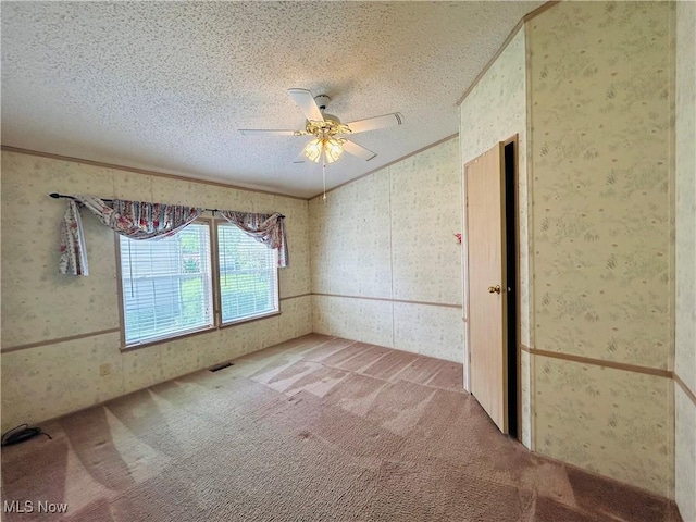 2270 S Commodore Ct, Lakeside-Marblehead, OH 43440 - empty room featuring carpet floors, ceiling fan, a textured ceiling, wallpapered walls, and crown molding