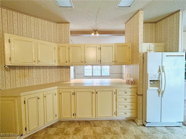 2270 S Commodore Ct, Lakeside-Marblehead, OH 43440 - kitchen with white fridge with ice dispenser, wallpapered walls, a textured ceiling, light countertops, and cream cabinetry