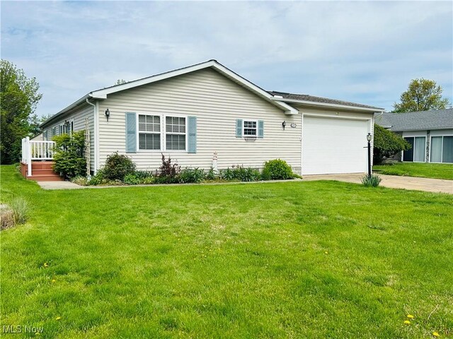 2270 S Commodore Ct, Lakeside-Marblehead, OH 43440 - view of side of home featuring concrete driveway, an attached garage, and a yard