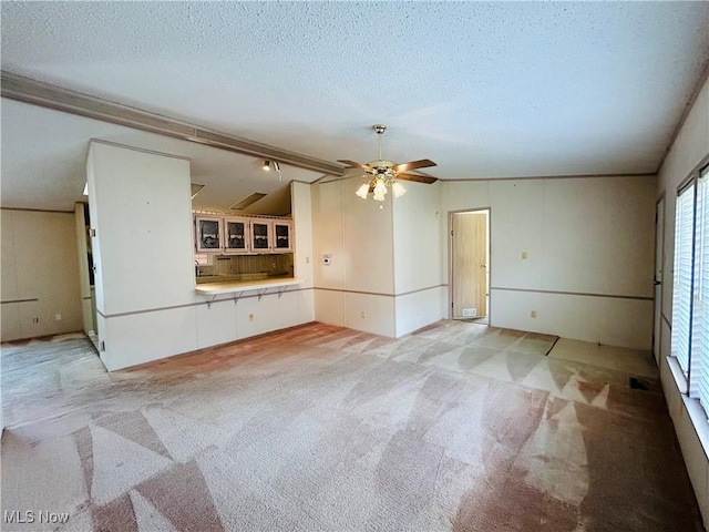 2270 S Commodore Ct, Lakeside-Marblehead, OH 43440 - unfurnished living room with light colored carpet, ceiling fan, and a textured ceiling