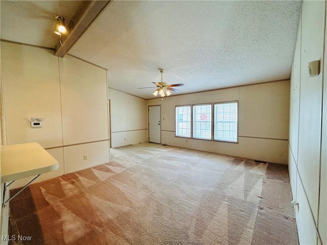 2270 S Commodore Ct, Lakeside-Marblehead, OH 43440 - unfurnished room featuring light colored carpet, a textured ceiling, a ceiling fan, and beam ceiling