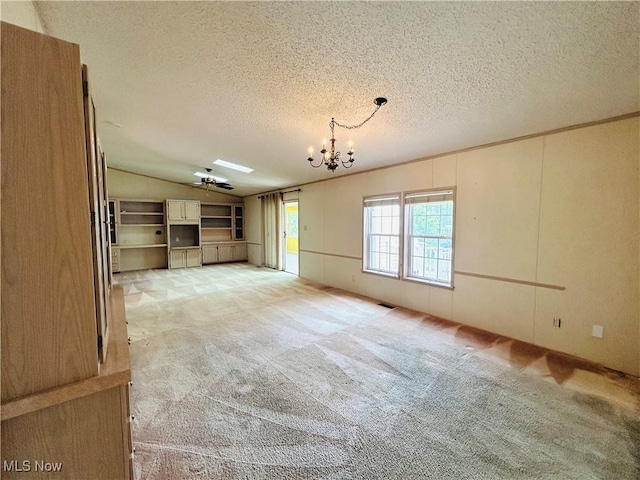 2270 S Commodore Ct, Lakeside-Marblehead, OH 43440 - unfurnished living room with light colored carpet, vaulted ceiling, a chandelier, a textured ceiling, and ceiling fan