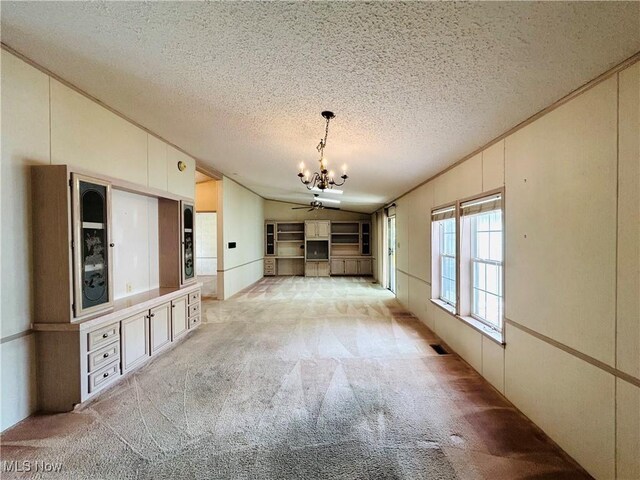 2270 S Commodore Ct, Lakeside-Marblehead, OH 43440 - unfurnished living room with a chandelier, a textured ceiling, light carpet, crown molding, and lofted ceiling
