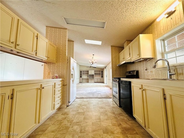 2270 S Commodore Ct, Lakeside-Marblehead, OH 43440 - kitchen with stainless steel gas stove, white refrigerator with ice dispenser, a textured ceiling, a sink, and a chandelier
