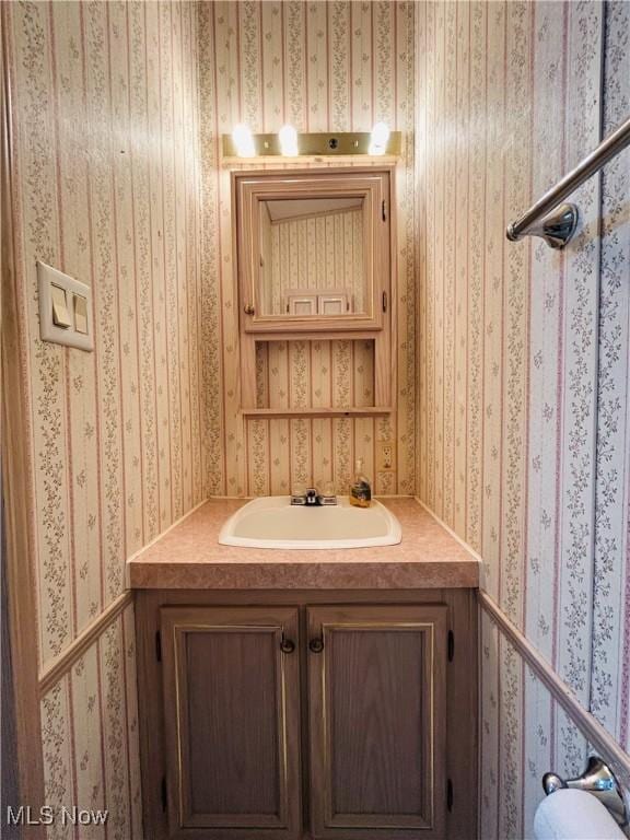 2270 S Commodore Ct, Lakeside-Marblehead, OH 43440 - bathroom with wallpapered walls and vanity
