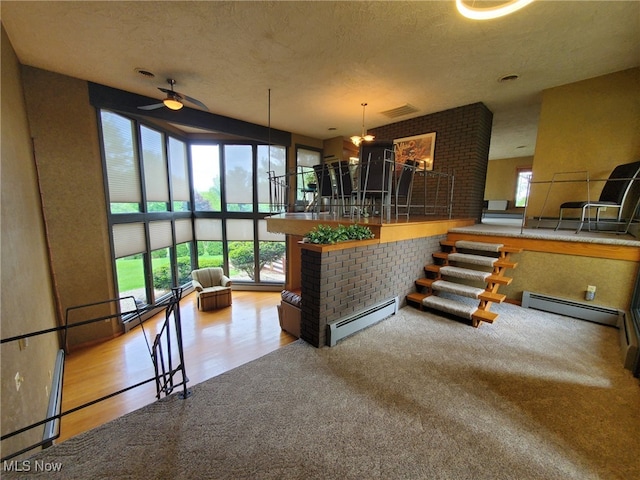 9651 Skyway Dr, Wadsworth, OH 44281 - kitchen with baseboard heating, a ceiling fan, wood finished floors, carpet flooring, and a textured ceiling