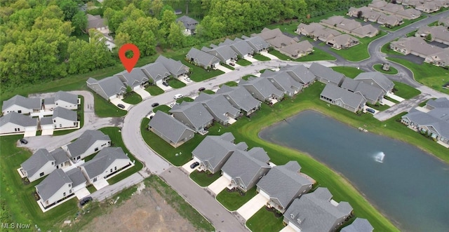 aerial view of property's location featuring nearby suburban area and a large body of water
