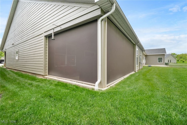 view of side of home with a lawn