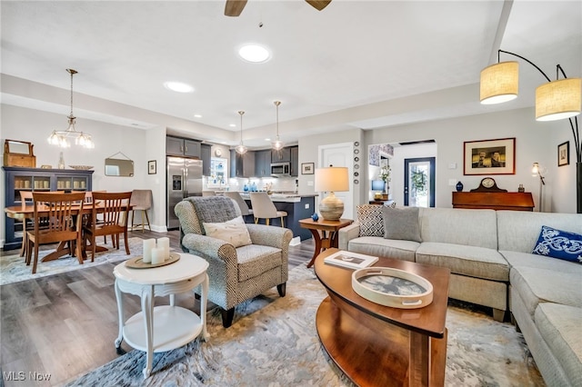 living area featuring wood finished floors, a ceiling fan, and recessed lighting