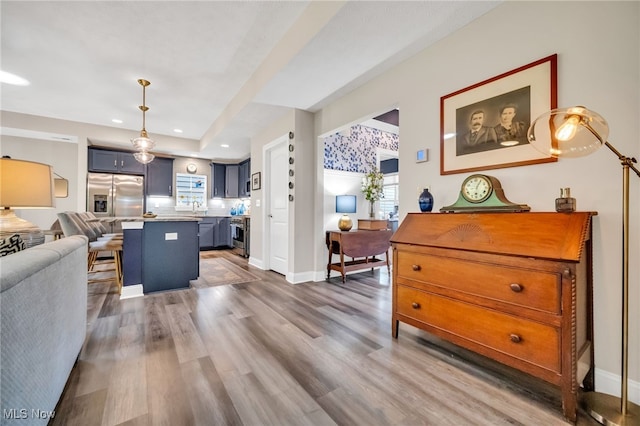living room featuring recessed lighting, baseboards, and dark wood-style floors