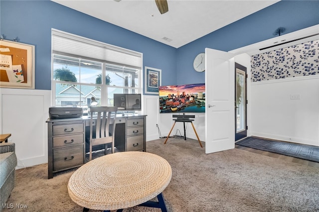 carpeted office space with ceiling fan