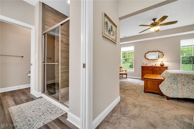 hall with baseboards and wood finished floors
