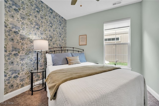 carpeted bedroom with wallpapered walls, baseboards, and ceiling fan