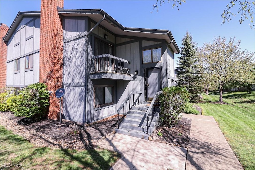 7085 Bristlewood Dr, Concord, OH 44077 - view of property exterior featuring a balcony, a lawn, and a chimney