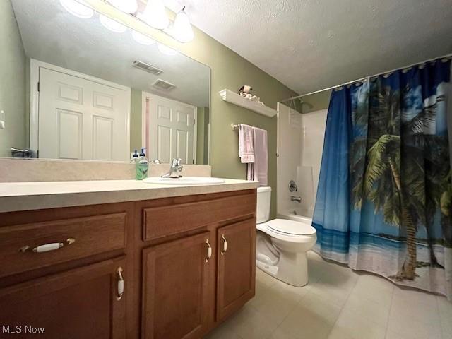 23003 Chandlers Ln Unit 219, Olmsted Falls, OH 44138 - full bath with vanity, toilet, shower / bath combo with shower curtain, a textured ceiling, and tile patterned flooring