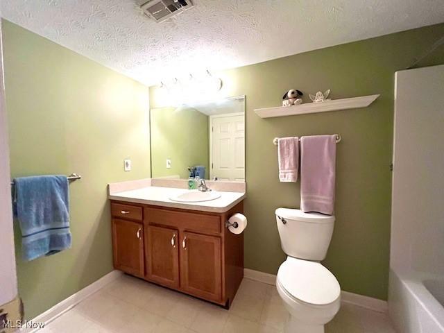 23003 Chandlers Ln Unit 219, Olmsted Falls, OH 44138 - full bath featuring a textured ceiling, toilet, vanity, a bath, and baseboards