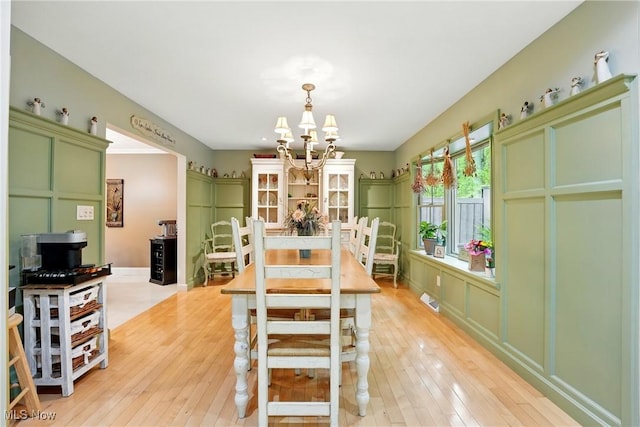 dining area featuring a chandelier and light wood-type flooring