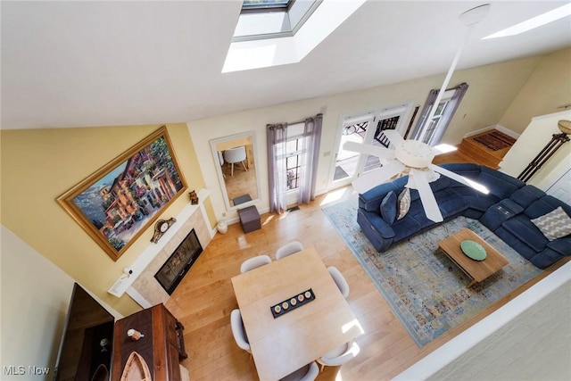 17466 Idylwild Ave, Lake Milton, OH 44429 - living area featuring a skylight, light wood-type flooring, baseboards, and a fireplace