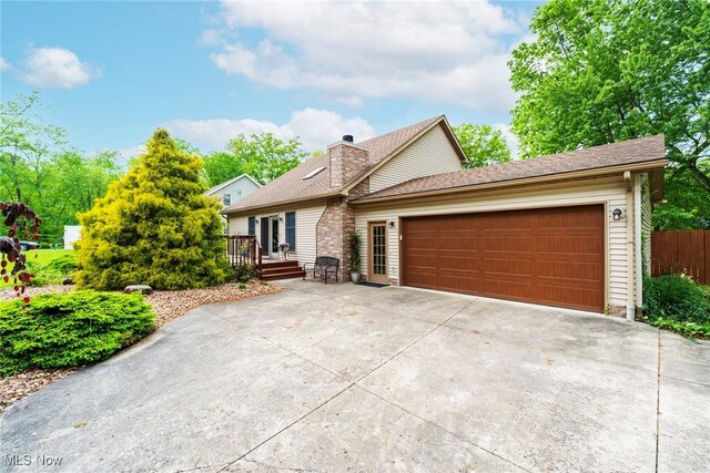 17466 Idylwild Ave, Lake Milton, OH 44429 - view of front of home featuring an attached garage, driveway, a wooden deck, fence, and a chimney
