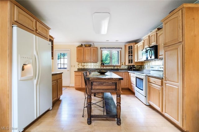 17466 Idylwild Ave, Lake Milton, OH 44429 - kitchen with white fridge with ice dispenser, electric range, black microwave, a sink, and healthy amount of natural light