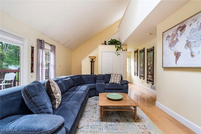 17466 Idylwild Ave, Lake Milton, OH 44429 - living area featuring light wood-style flooring, baseboards, and lofted ceiling