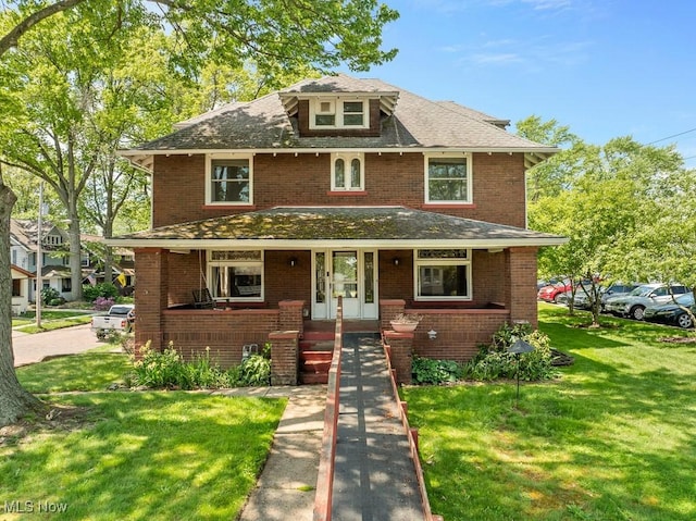 1447 S Arch Ave, Alliance, OH 44601 - american foursquare style home with covered porch, a front yard, brick siding, and a shingled roof