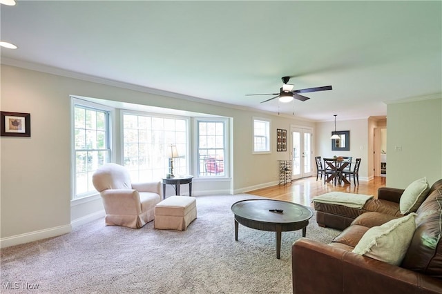 7304 Glastonbury Dr, Hudson, OH 44236 - living area featuring ornamental molding, baseboards, ceiling fan, and light colored carpet