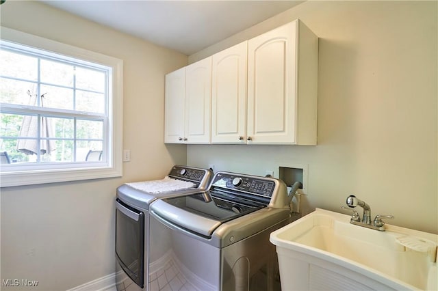7304 Glastonbury Dr, Hudson, OH 44236 - washroom with washing machine and dryer, cabinet space, and baseboards