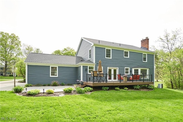 7304 Glastonbury Dr, Hudson, OH 44236 - back of property featuring a deck, a chimney, a lawn, central AC, and french doors