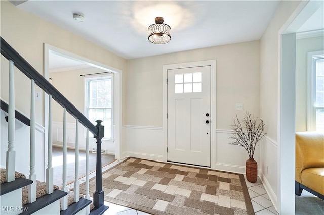 7304 Glastonbury Dr, Hudson, OH 44236 - foyer with healthy amount of natural light, stairs, and light tile patterned flooring
