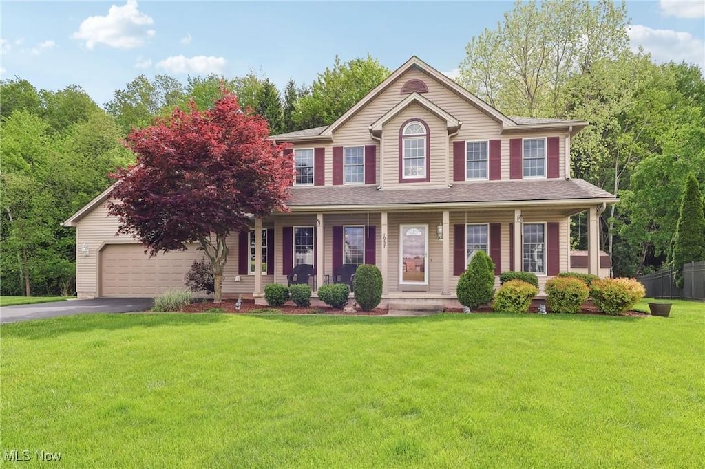 1957 Old Farm Trl, Austintown, OH 44515 - colonial house with asphalt driveway, a porch, and a front lawn