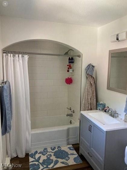 566 N Walnut St, Wooster, OH 44691 - bathroom featuring shower / bathtub combination with curtain, vanity, and wood finished floors