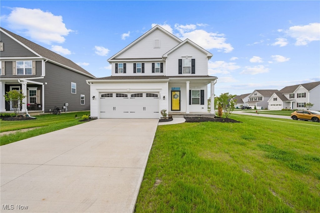 1582 Slick Rock Dr, Painesville, OH 44077 - view of front of house with concrete driveway, a front yard, an attached garage, and a porch
