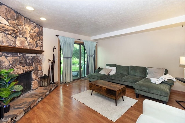 80 Landings Way, Avon Lake, OH 44012 - living area with a textured ceiling, wood finished floors, a fireplace, and recessed lighting