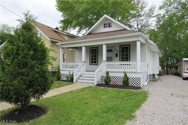 923 W 58th St, Ashtabula, OH 44004 - view of front of house with a porch, a front lawn, and roof with shingles