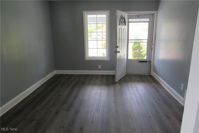923 W 58th St, Ashtabula, OH 44004 - entryway with dark wood-type flooring and baseboards