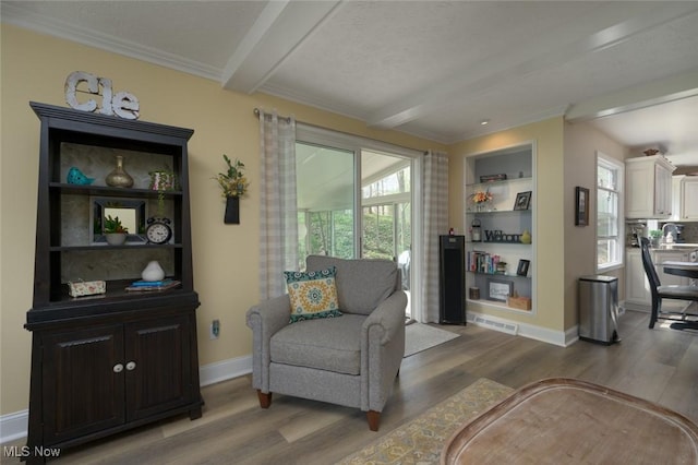 6352 Creekside Trl, Solon, OH 44139 - living area featuring wood finished floors, beam ceiling, baseboards, and ornamental molding