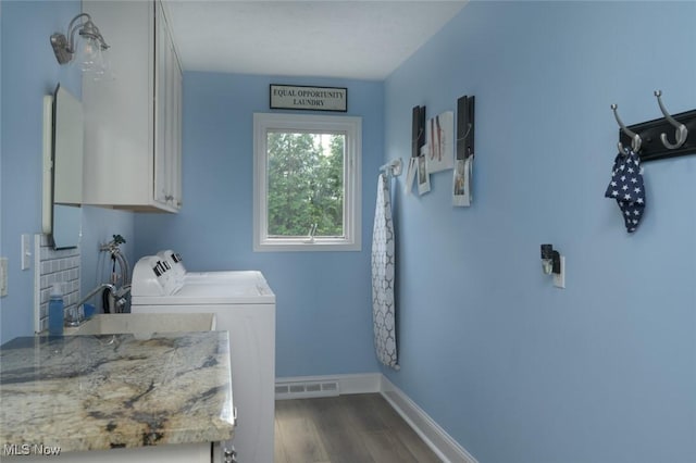 6352 Creekside Trl, Solon, OH 44139 - washroom with cabinet space, washing machine and clothes dryer, dark wood finished floors, and baseboards