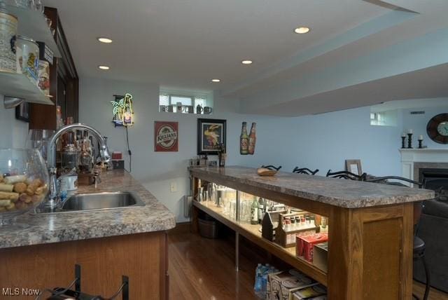 6352 Creekside Trl, Solon, OH 44139 - bar area featuring a sink, wood finished floors, recessed lighting, and a fireplace