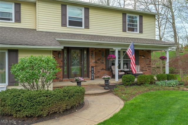 6352 Creekside Trl, Solon, OH 44139 - view of front facade with covered porch, brick siding, and roof with shingles