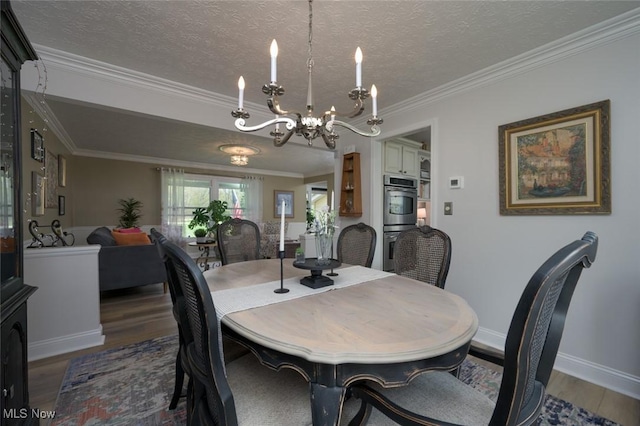 6352 Creekside Trl, Solon, OH 44139 - dining room with a chandelier, wood finished floors, crown molding, a textured ceiling, and baseboards