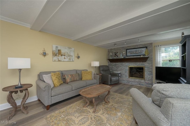 6352 Creekside Trl, Solon, OH 44139 - living room featuring beamed ceiling, wood finished floors, baseboards, and a fireplace