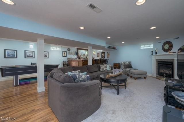 6352 Creekside Trl, Solon, OH 44139 - living area with recessed lighting, billiards, bar, a glass covered fireplace, and light wood finished floors