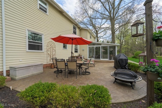 6352 Creekside Trl, Solon, OH 44139 - view of patio / terrace featuring an outdoor fire pit, a sunroom, a grill, and outdoor dining space